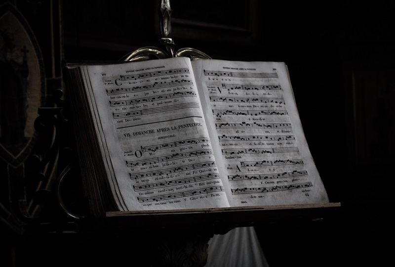 Sheet music with lyrics in French on a stand