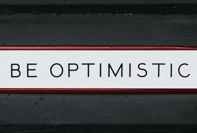 A sign that says 'Be optimistic'